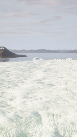 a stunning view of a frozen lake with mountains in the background