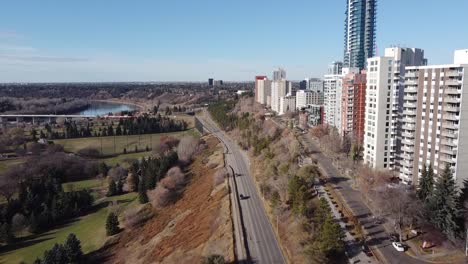 2-2 aerial rise fly over vip park adjacent to road by vip rivers ege condominiums apartments high rise tower on a blue sky sunny fall day with hardly any rush hour traffic during covid-19 lockdown