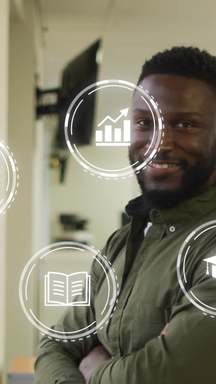 Animation of multiple digital icons against african american man with arms crossed smiling at office