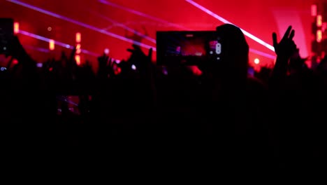 Silhouetted-Fans-at-Nighttime-Music-Concerts:-Recording-Videos,-Holding-Smartphones,-and-Dancing-with-Lights