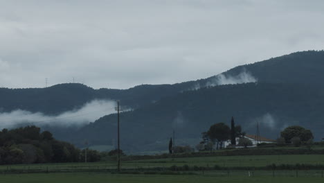 timelapse zoom in of the movement of clouds after a storm in a small catalan town