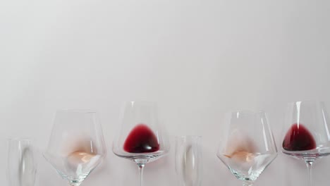 glasses with diverse types of wines lying on grey surface with copy space