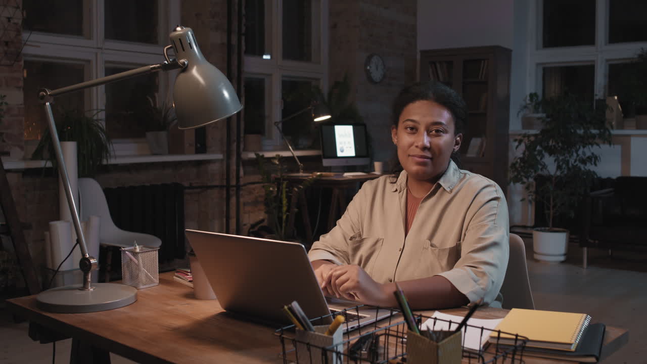 Woman Working on Laptop at Night