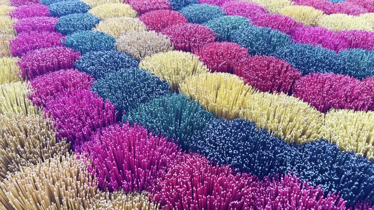 Bundles of colorful incense sticks fill a Vietnamese shop, showcasing vibrant hues and aromatic scents. A sensory experience highlighting fragrance, texture, and traditional craftsmanship