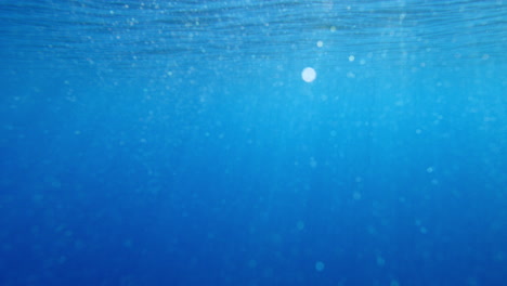 light underwater godrays. sun beams from beneath the ocean surface in 4k. liight shafts vfx element background. diving vacation holidays.