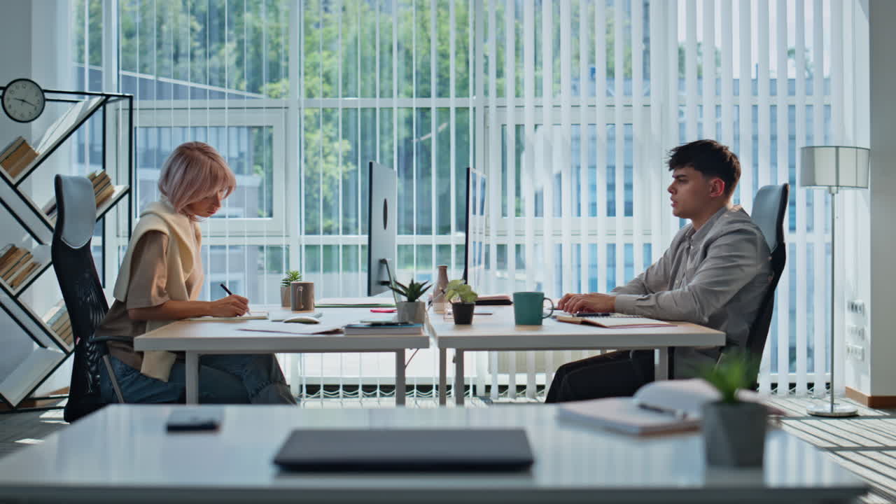 Involved managers sitting workplace panoramic office indoors. Coworkers working