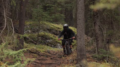 biker rides toward the camera pan