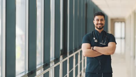 male doctor of arab appearance looks into the camera and smiles