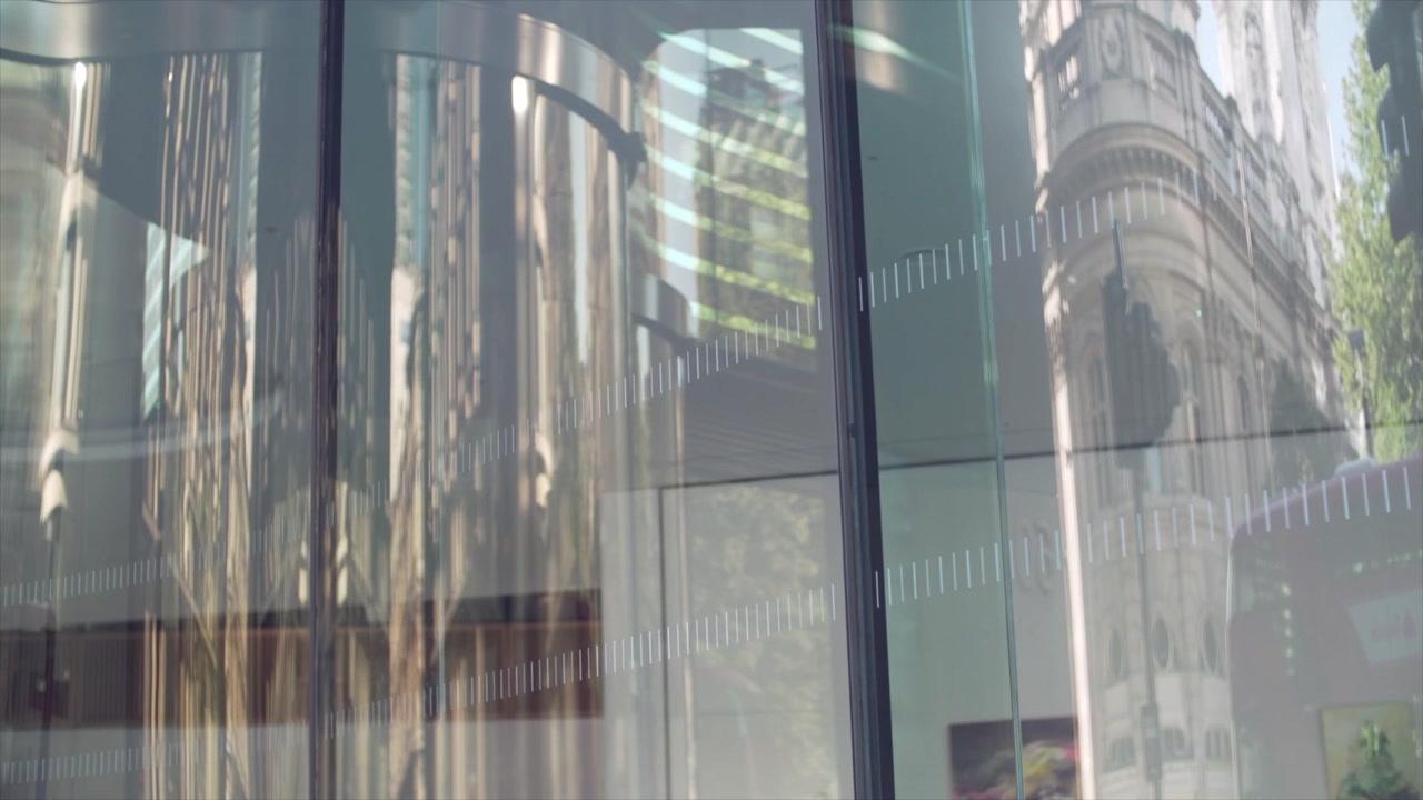 Abstract reflection of city in the glass. A bus passing by reflecting on the glass.