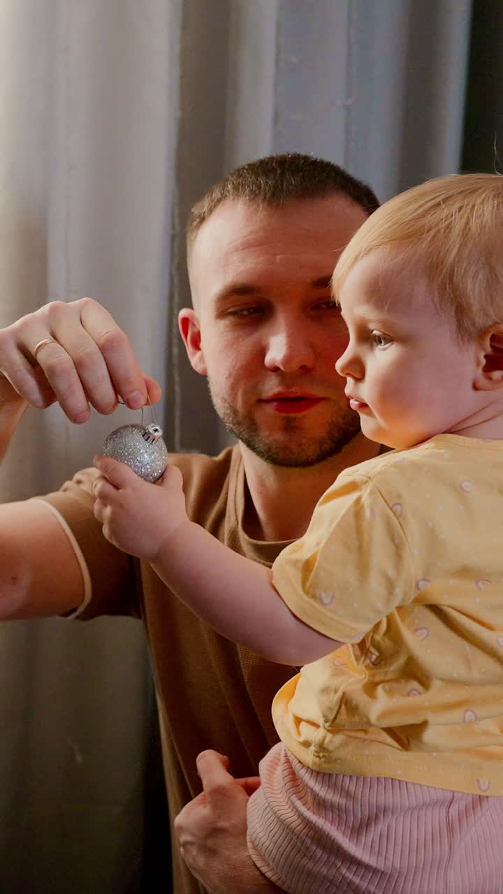 A Tender Moment Between Father and Child: A Close-Up Interaction Showcasing Trust, Curiosity, and Love in a Warm Domestic Setting with Soft Lighting and Intimate Expressions