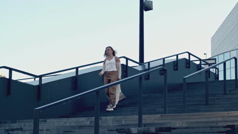 woman walking up modern city stairs