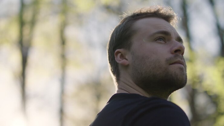 Man looking up outdoors in nature