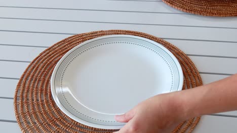 a table is set with plates and cutlery for a fried chicken meal in a bright, casual setting