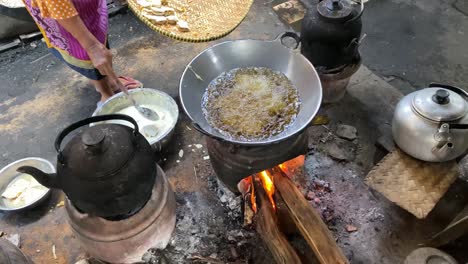 the process of cooking fried foods such as tofu, tempeh in a traditional skillet and stove using coals and a stove-2