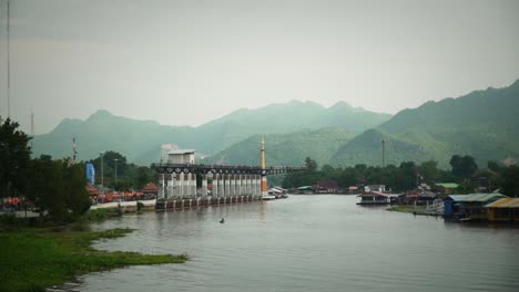 scenic river view of the kanchanaburi skywalk glass bridge over the kwae yai river