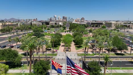 american flag, arizona state flag, and pow mia flags waving in on capitol grounds