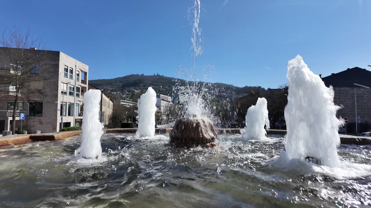 Guimaraes city monuments fresh water fountain in slow motion. Camera closing in.