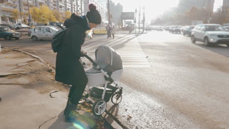 mother having problems with pushing pram in the street