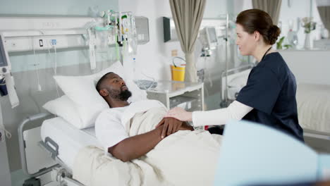 diverse female doctor and male patient talking in hospital room, slow motion