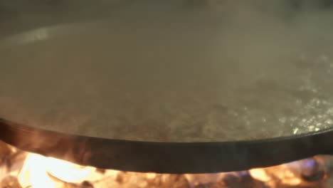 the chicken is being prepared on a large frying pan