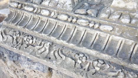 Close-up-of-ancient-Roman-relief-carvings-in-Carthage,-Tunisia,-showing-historical-detail