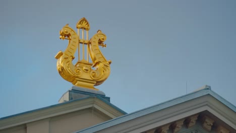 new gilded lyre on roof of concertgebouw amsterdam handeld detail