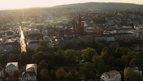 nice drone circle around the marktkirche in wiesbaden with the city center square on a sunny summer evening