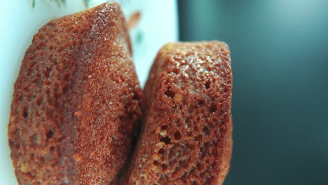 a vertical macro close up shot of tasty cupcakes, on a 360 rotating stand, cinematic studio lighting, slow motion, smooth movement, 4k video