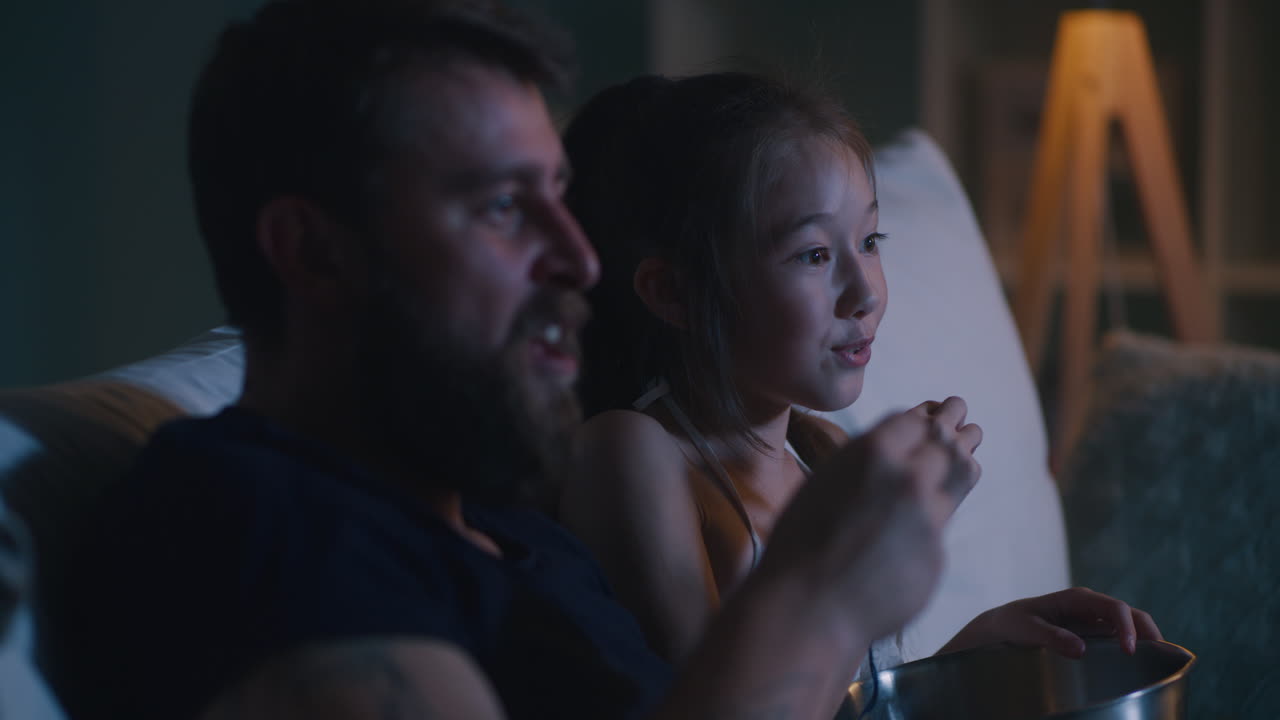Father and Daughter Watching a Movie