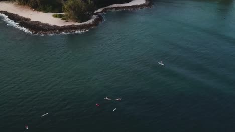 drone aerial surfers on water blue waves hawaii