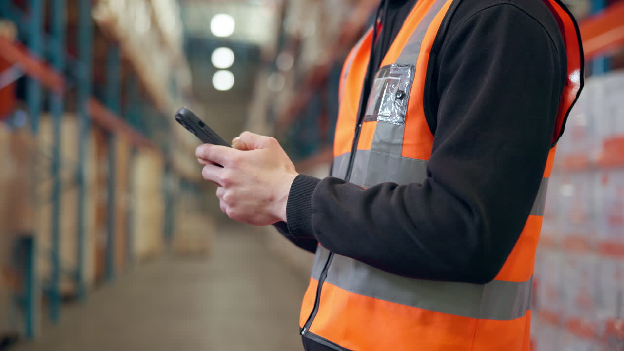 Warehouse worker using mobile phone