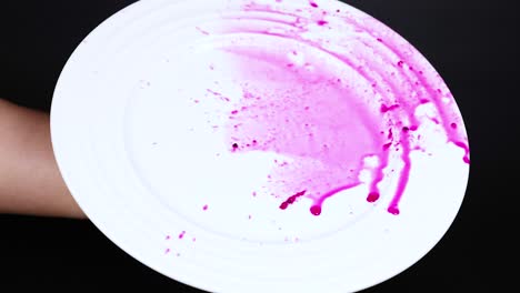 a plate spins with vibrant pink liquid