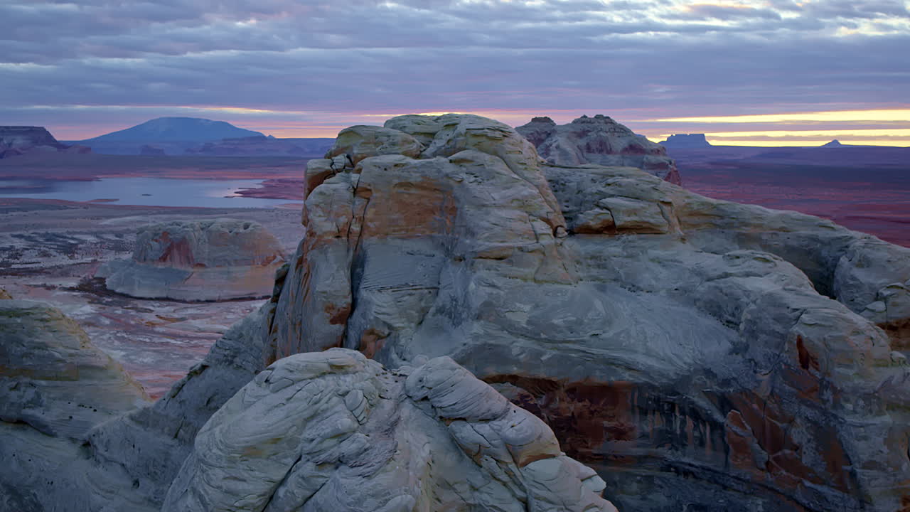 The drone glides through Glen Canyon, focusing on the intricate layers and textures of its rock formations.