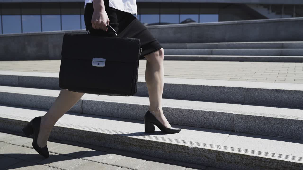 Business Woman in Formal Suit with Briefcase is Walking in City