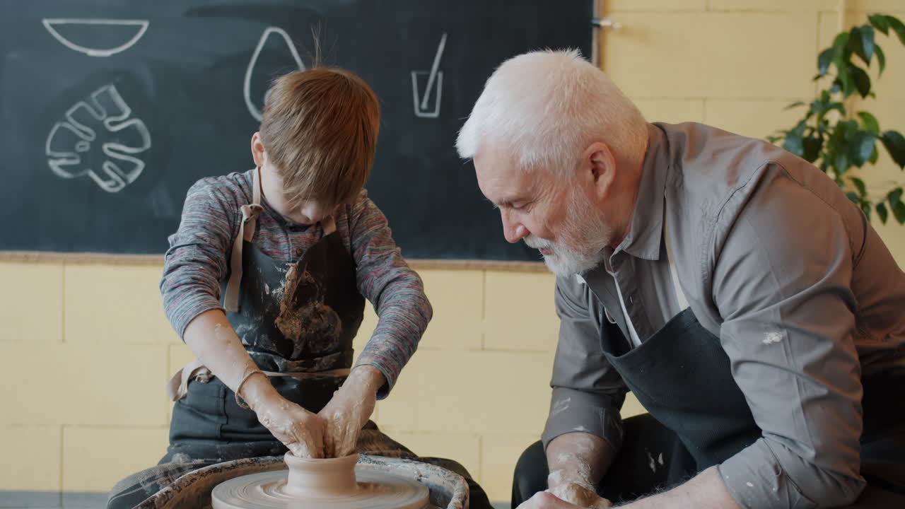 Grandfather and Grandson Learning Pottery Together