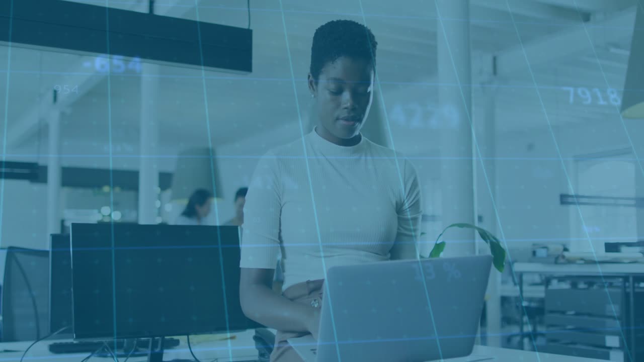 Businesswoman working on laptop with data processing animation overlay in office