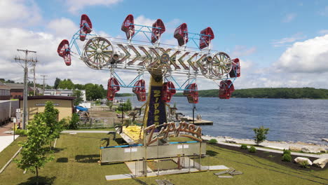 static aerial footage of s carnival fairground ride called zipper, city of bath, maine