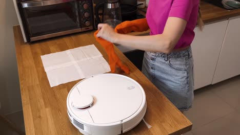 woman cleaning with robot vacuum