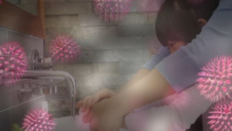 animation of macro coronavirus covid-19 cells spreading over asian mother and daughter washing hands