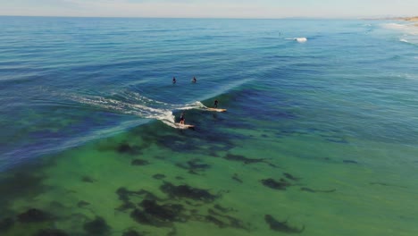 Surfers-At-Pacific-Beach-In-San-Diego,-United-States---drone-shot