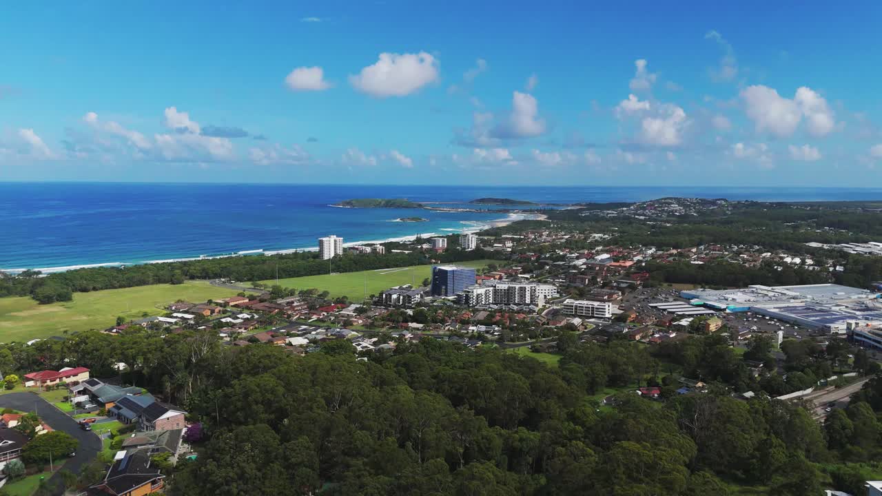 Aerial: cityscape and landscape of Coffs Harbour during the day in the Mid North Coast of New South Wales, Australia, establishing drone shot