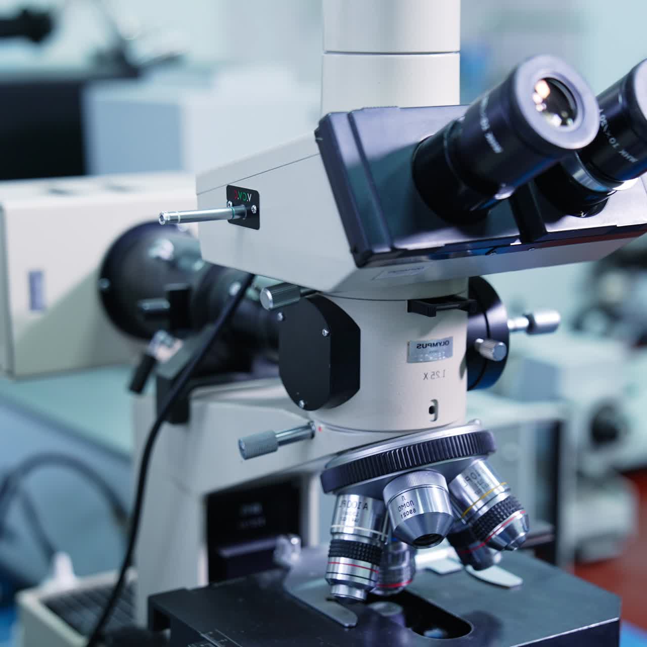 Optical microscope - science and laboratory equipment. Automated scientific laboratory microscope for research in medical development clinical laboratory. Close up