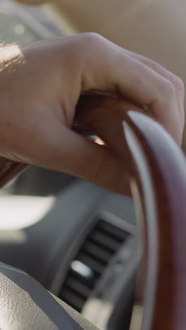 person drives car and checks time with smart wristwatch closeup. man enjoys road trip by modern car and uses personal device. guy at steering wheel