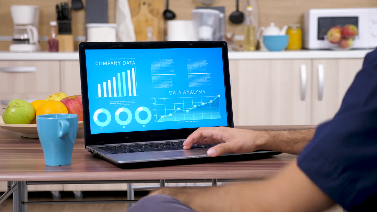 Data Analysis on Laptop in Kitchen