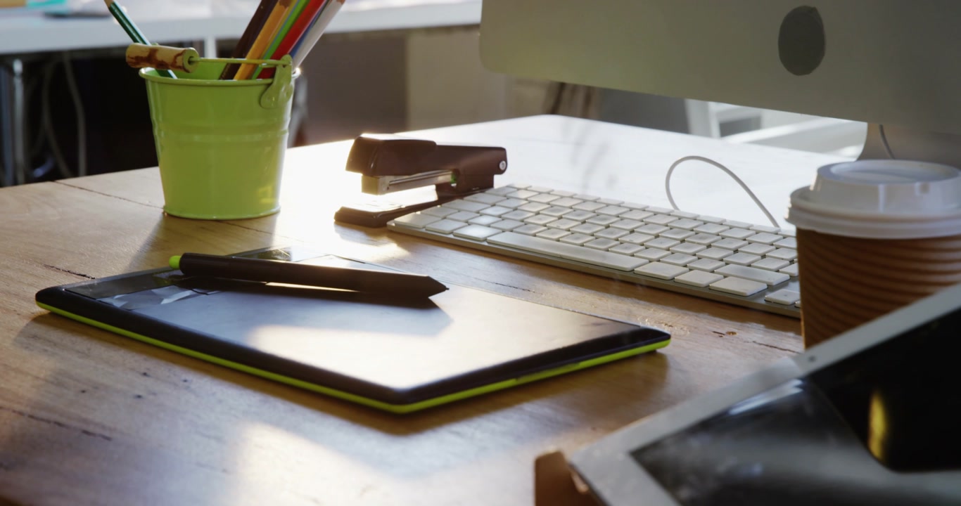 Cam pulling back dotted glare fading tablet stylus staying desk tools appearing revealing workspace