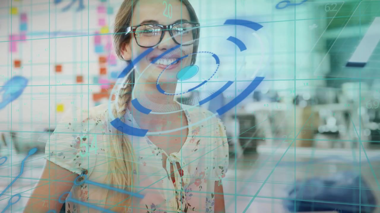 Woman typing at laptop in tech workspace, activating blue HUD graphics, adjusting glasses, smiling