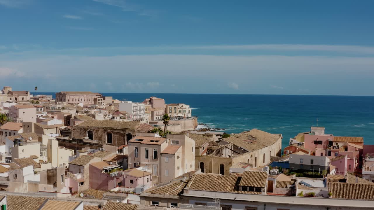 Aerial view of Ortigia island. Old town in Syracuse. Flying low over historic architecture buildings in charming Italian town. UNESCO world heritage site in Sicily.