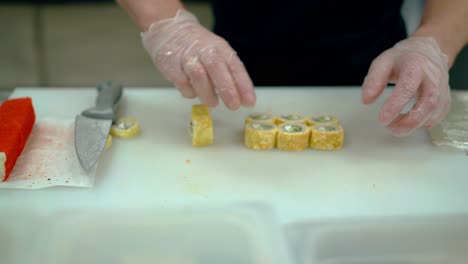 cook chops and serves japanese rolls wrapped in an omelette