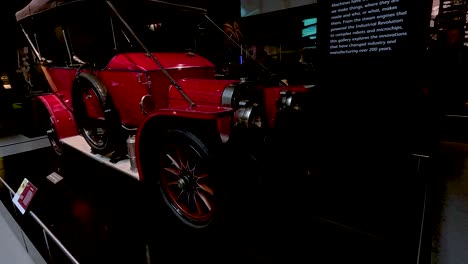 classic red car showcased in museum exhibit