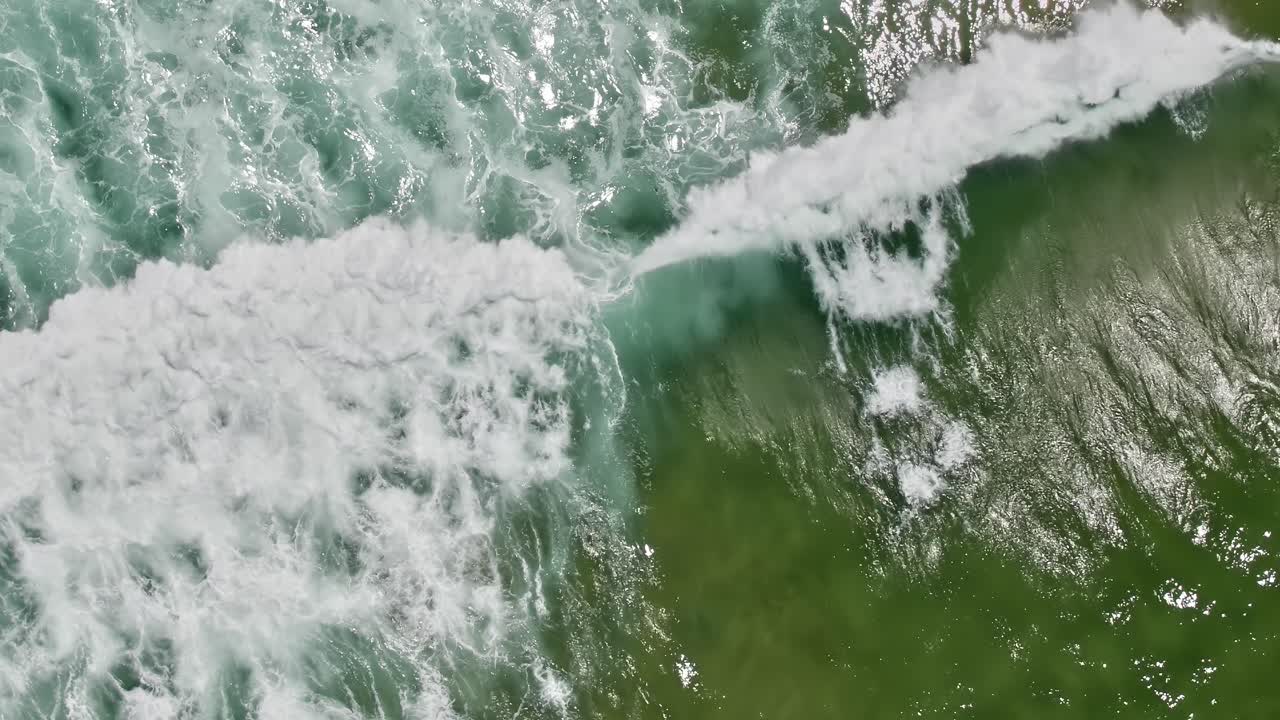 Waves crashing on the shore in Portugal captured from above